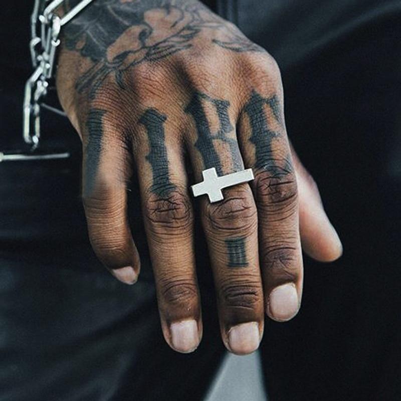 Tattoo of ring, cross and chain around fingers wrist and hand Stock Photo -  Alamy